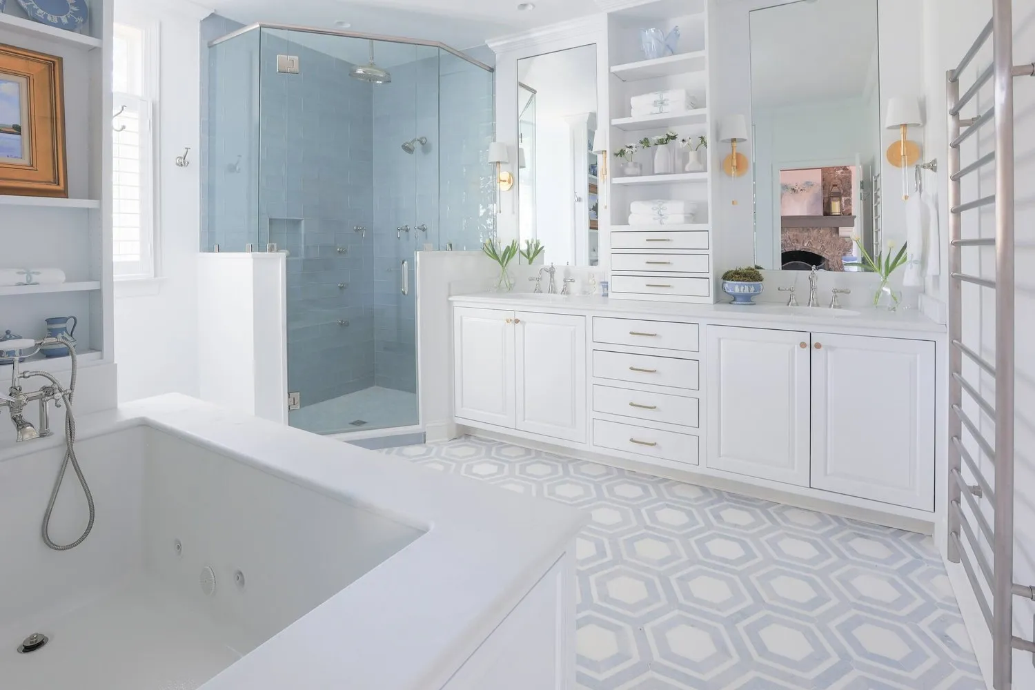 A bright primary bath with a soaking tub, a glass shower and a hexagonal tile floor.
